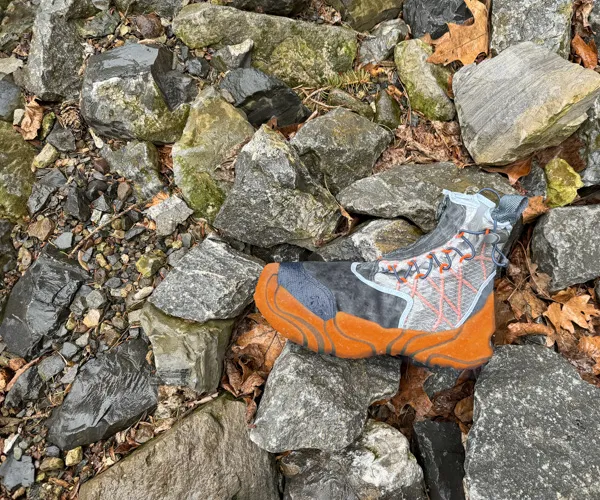 A hiking shoe on rocks.