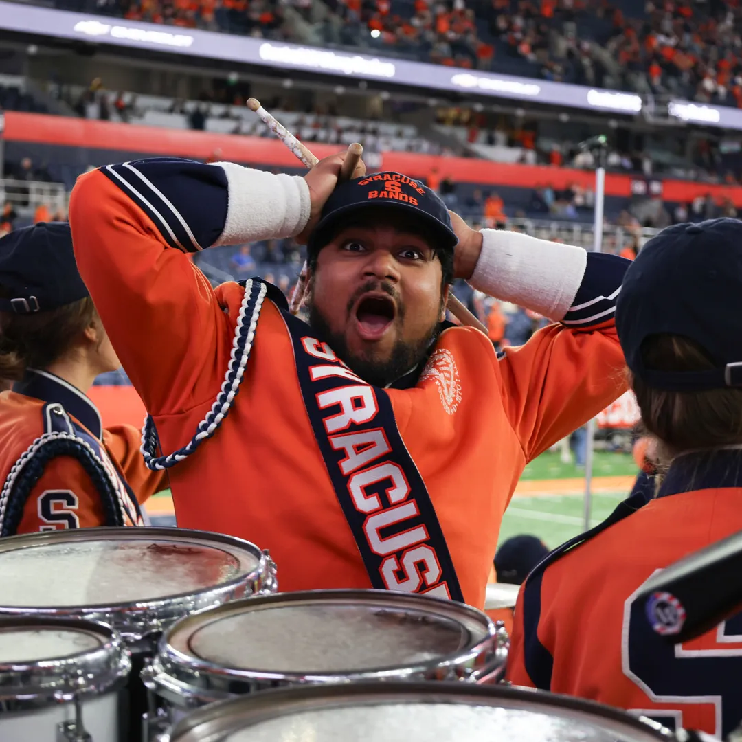 A person looks in surprise by drums.
