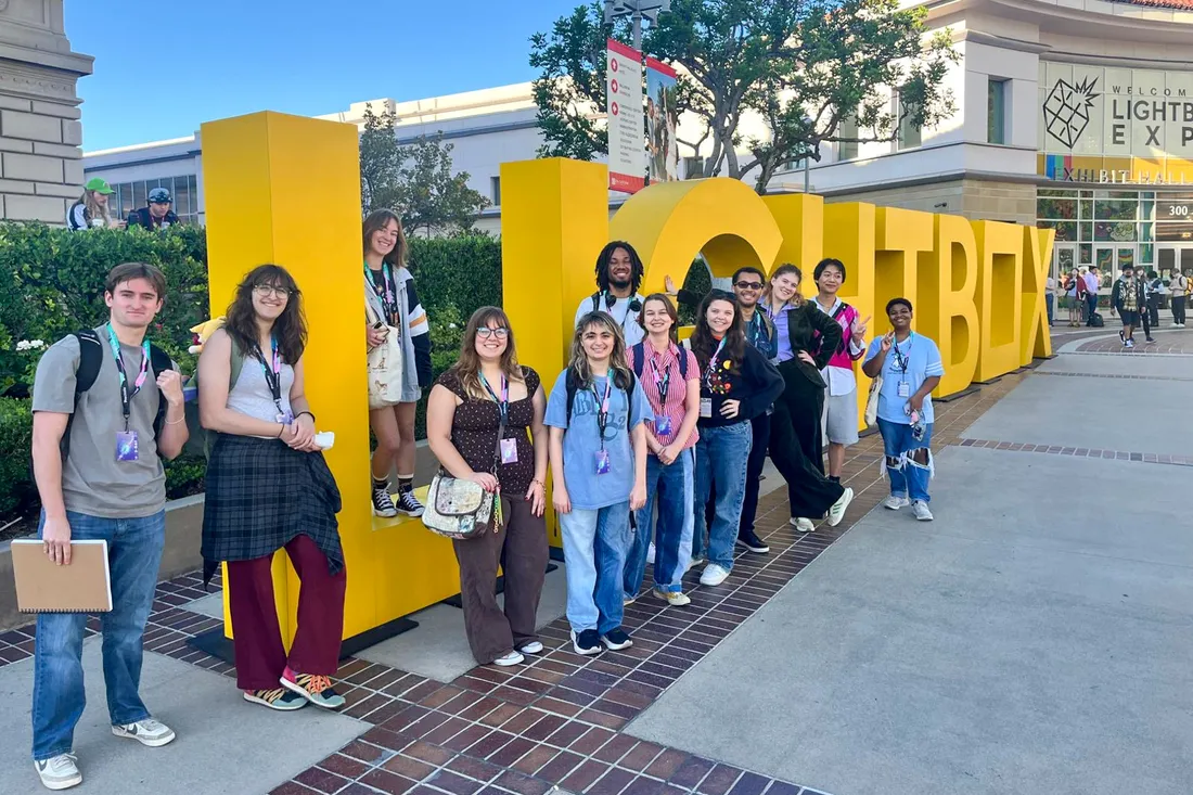Students stand next to giant, yellow letters that spell out Lightbox.