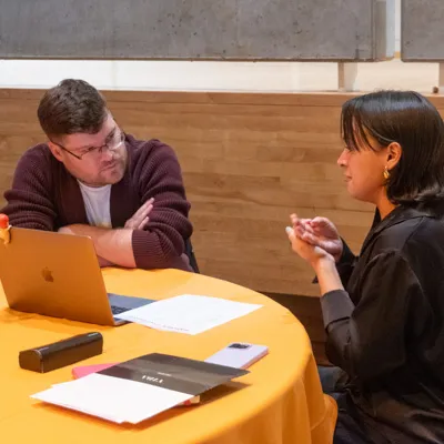 A student speaks with an alumnus.