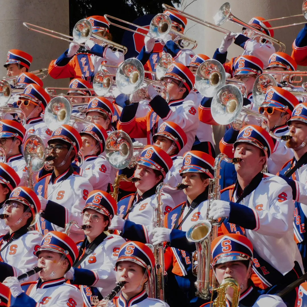 Members of the marching band play on the steps of Hendricks Chapel.