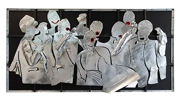 A sculpture in metal of people singing.