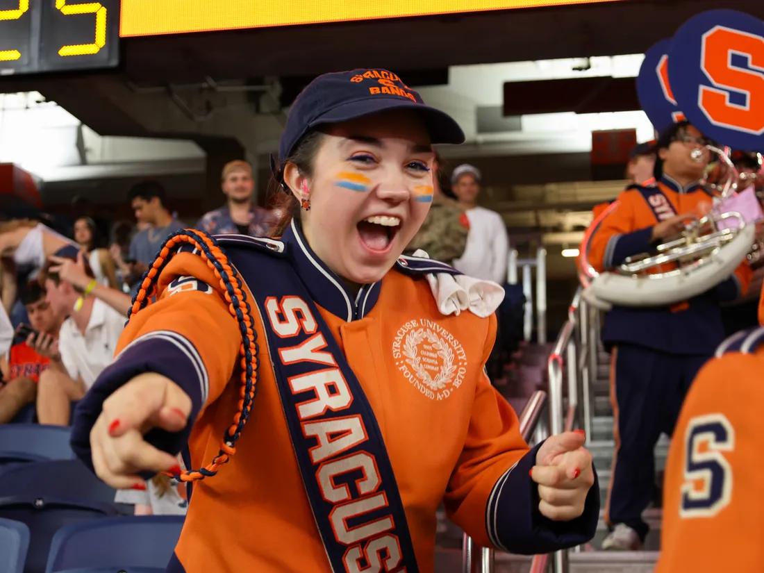 A member of the band points and smiles.