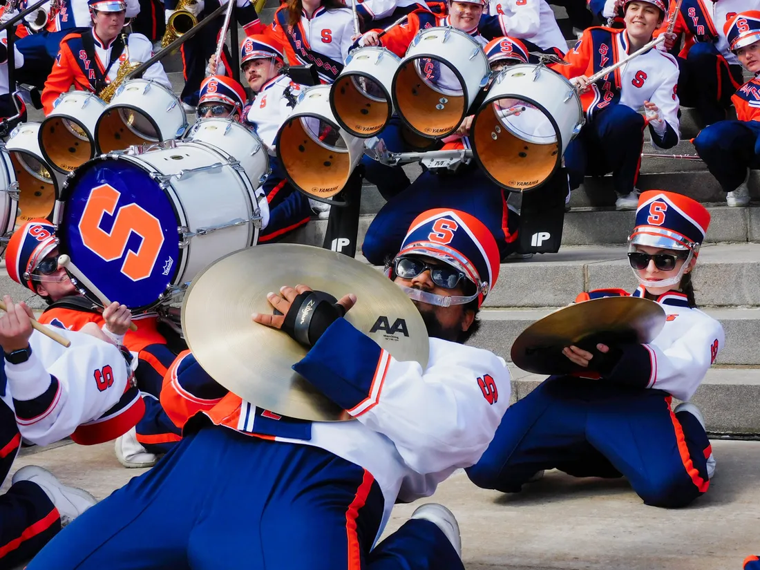 Members of the band dance on the steps of Hendricks Chapel.