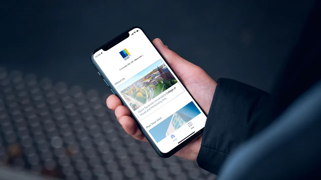 A person holds a phone that is open to the free digital guide available through Bloomberg Connects.