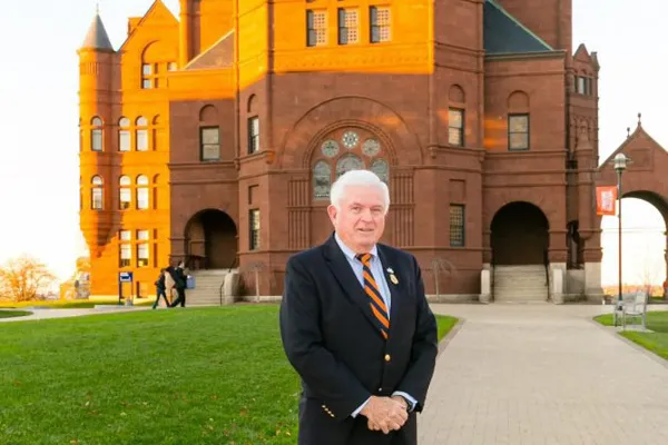 Bill Harris ’65, G’79 stands in front of Crouse College.