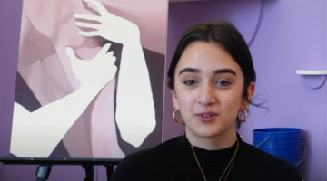 Danielle Russo in front of a painting.