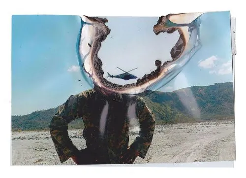 A solider with a burnt circle where the head should be.