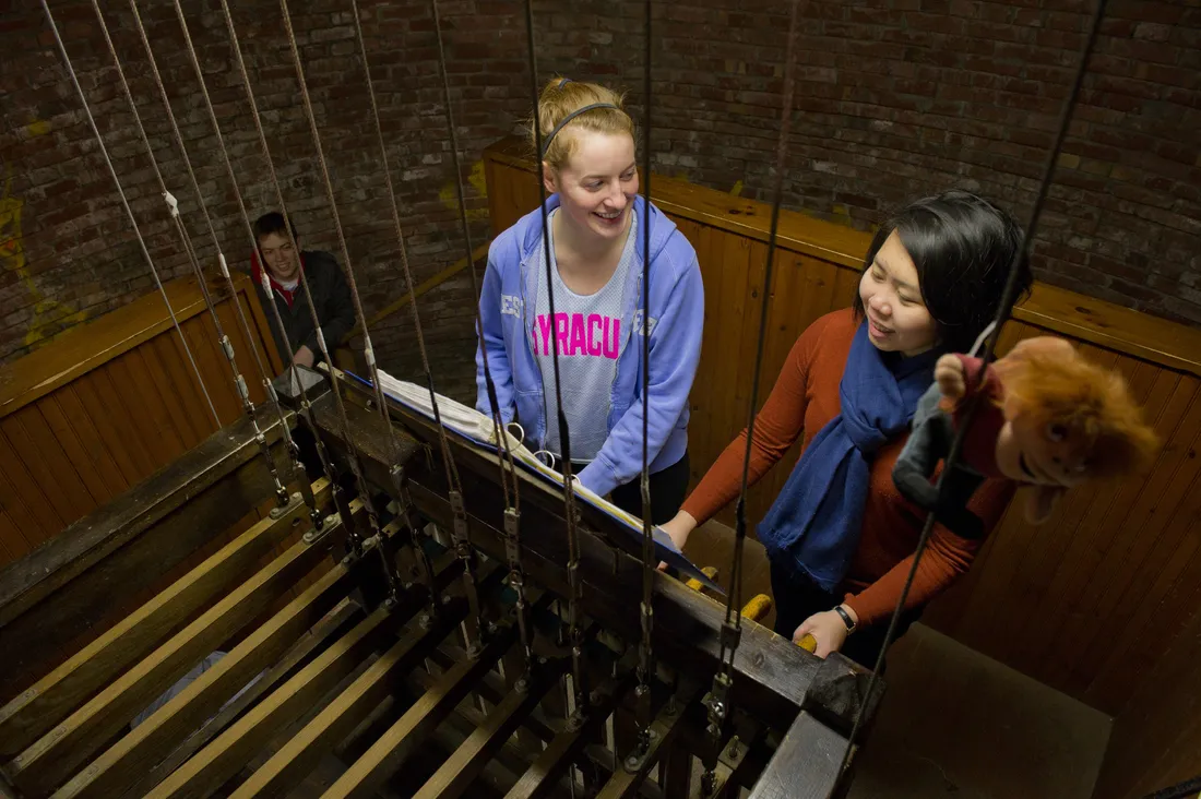 A group of students ring the Crouse Chimes.
