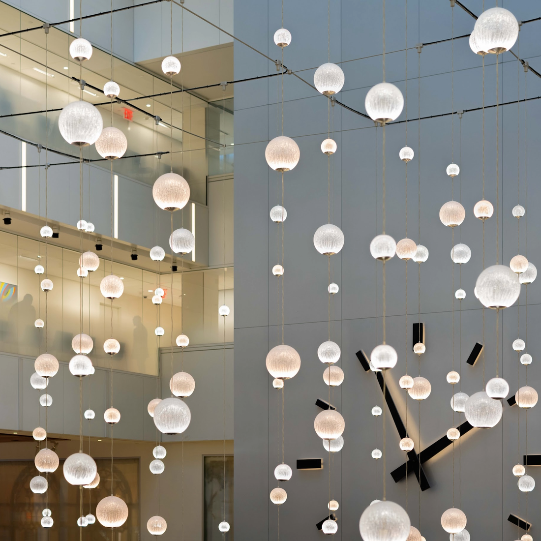Glass balls hang from a ceiling.