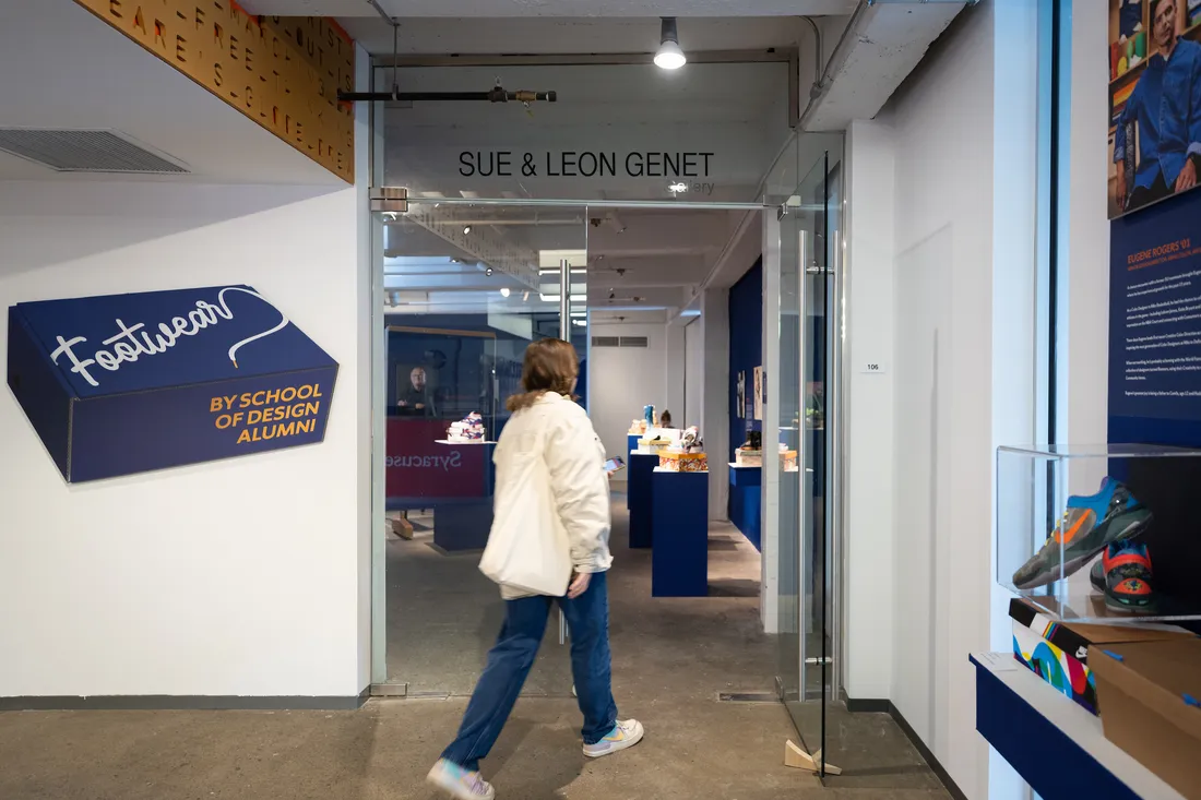 A person enters a gallery door.