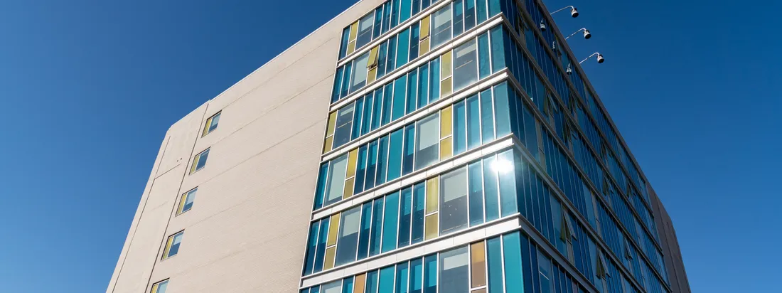 A tall building with a blue sky behind it.