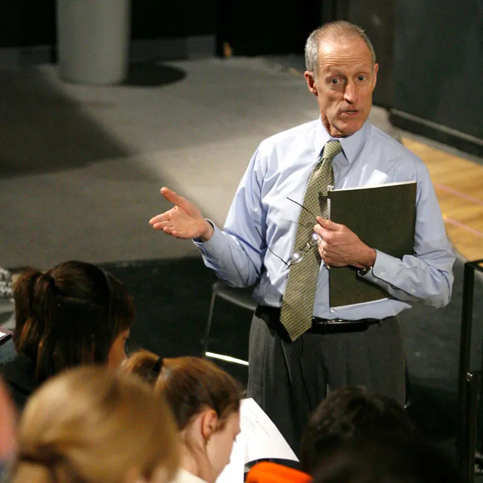 Jim Clark stands and talks to a group of students in a theater.