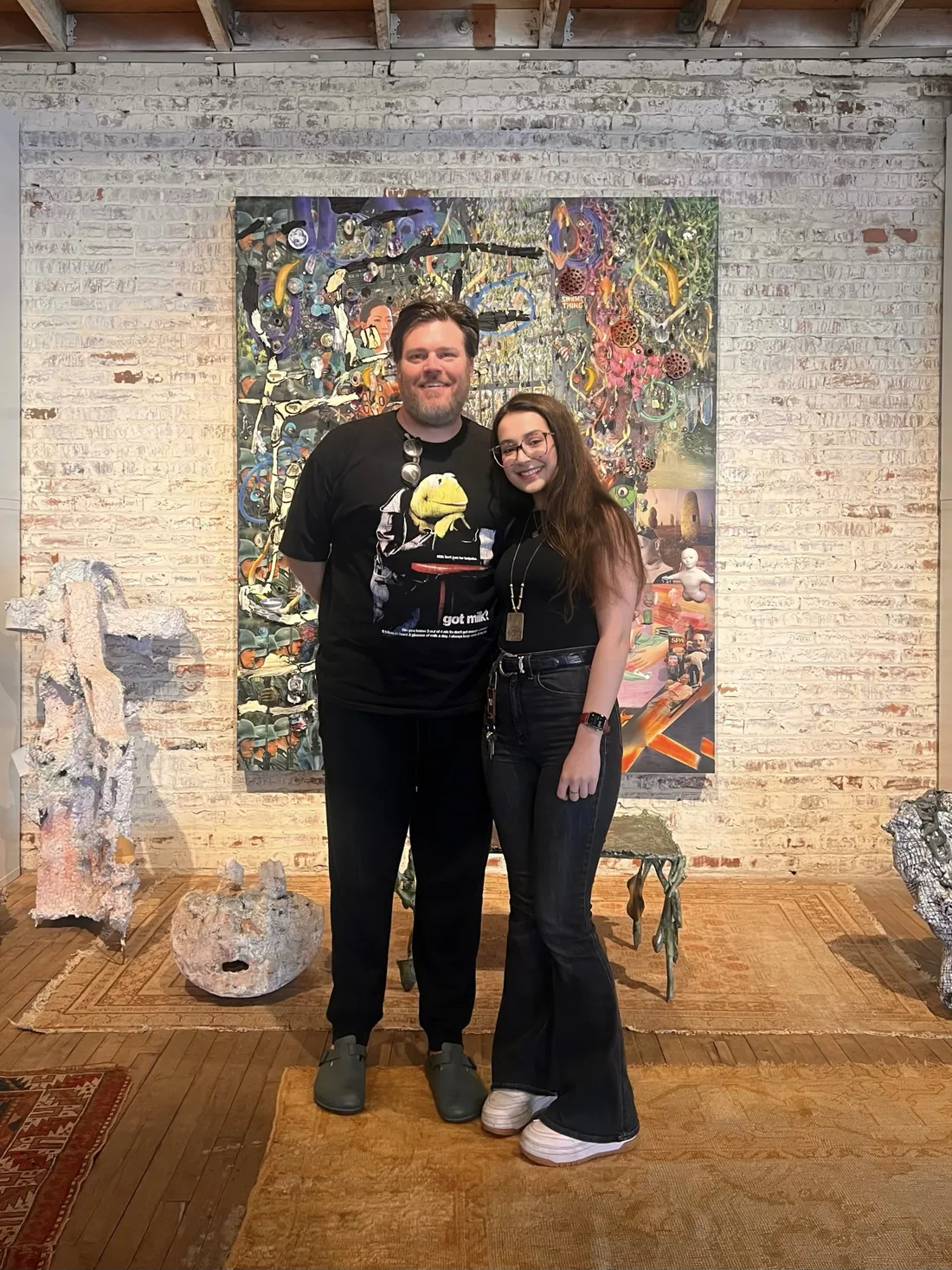 Elliott Hundley and Sophia Hashemi in front of a piece of art.