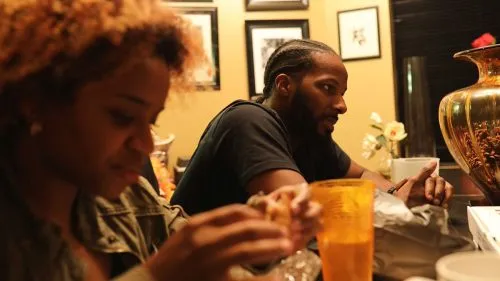 Photograph of individuals sitting at a table.