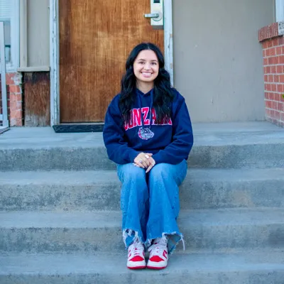 Andrea Moreno sits on steps.