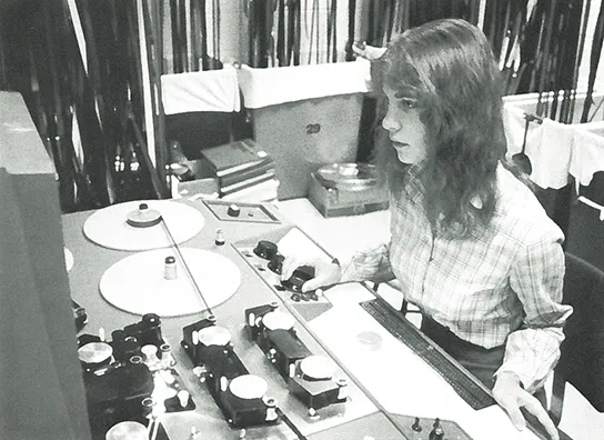 A student uses film editing equipment.