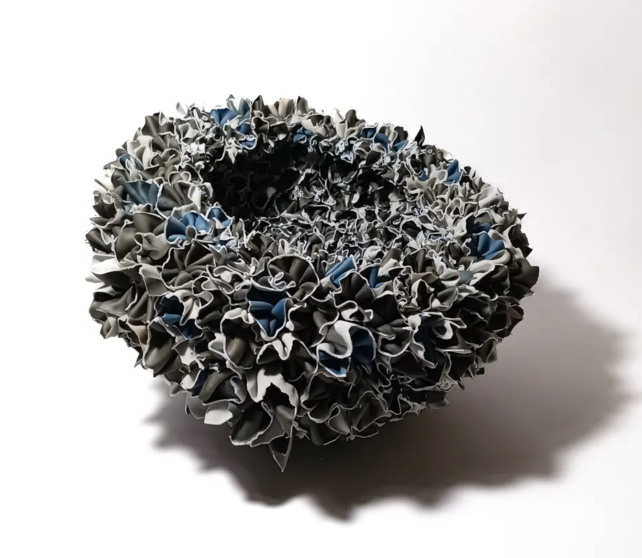 A round, textured abstract sculpture.