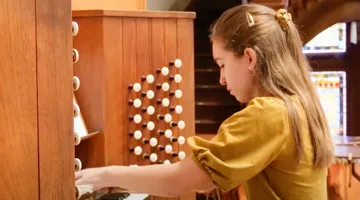 A student plays the organ.