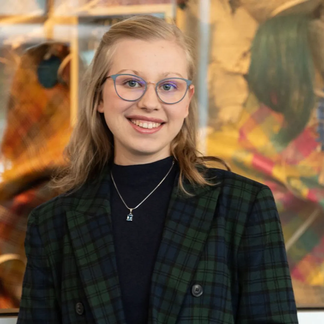 Hannah Payne in front of a piece of art.