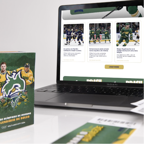 A modern sports-themed workspace featuring a laptop displaying a Brazil hockey team website with game news and player images. Beside the laptop are branded promotional materials, including a green-and-yellow Olympic-themed booklet and matching printed cards on a clean white desk.