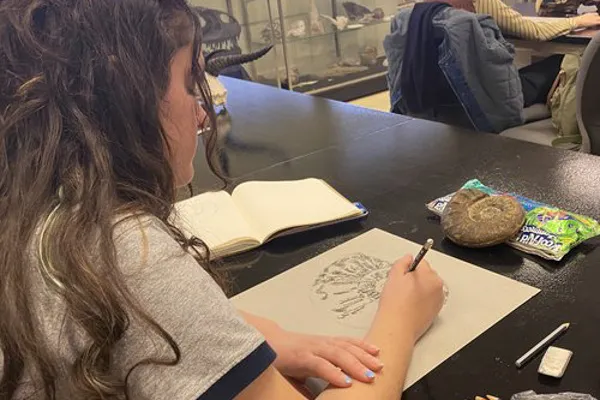 A student draws an ancient lifeform.