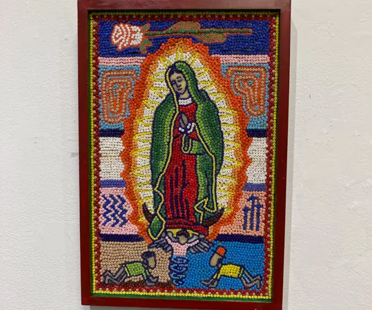Beaded work of a saint-like figure.