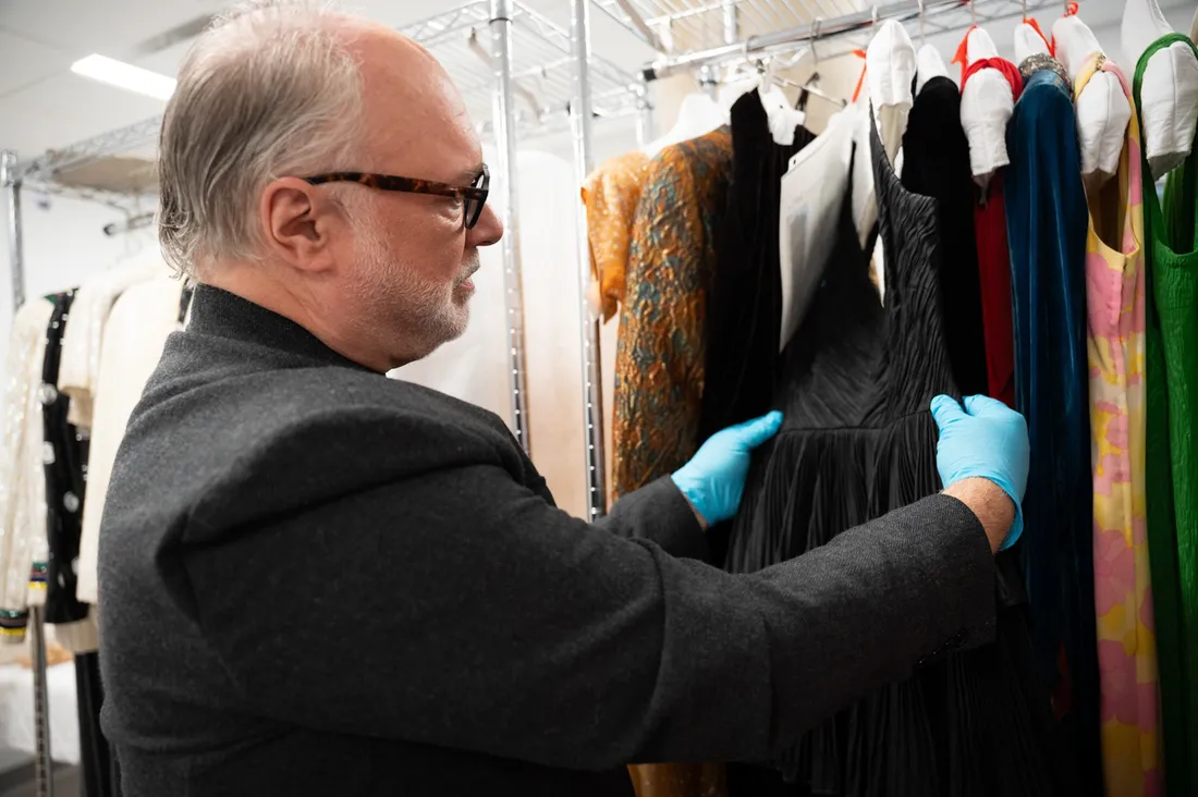 Two faculty members in the Sue Ann Genet Costume Collection at Syracuse University.