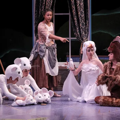 5 people performing a play on stage.