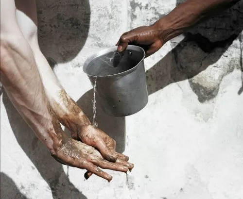 Photograph of people washing their hands.