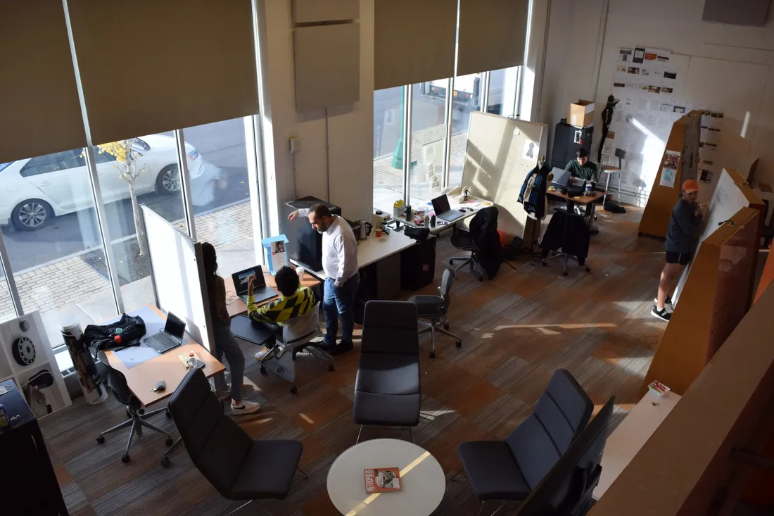 Looking down at a group of people working in a studio.