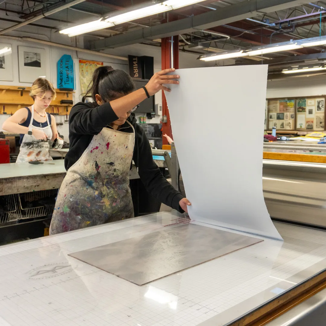 A student makes a print.