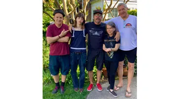Ian MacKaye, Harper Grohl, Dave Grohl, Amanda MacKaye, and Don Zientara pose and smile.