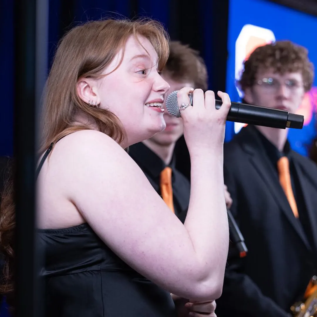 A person sings on stage.