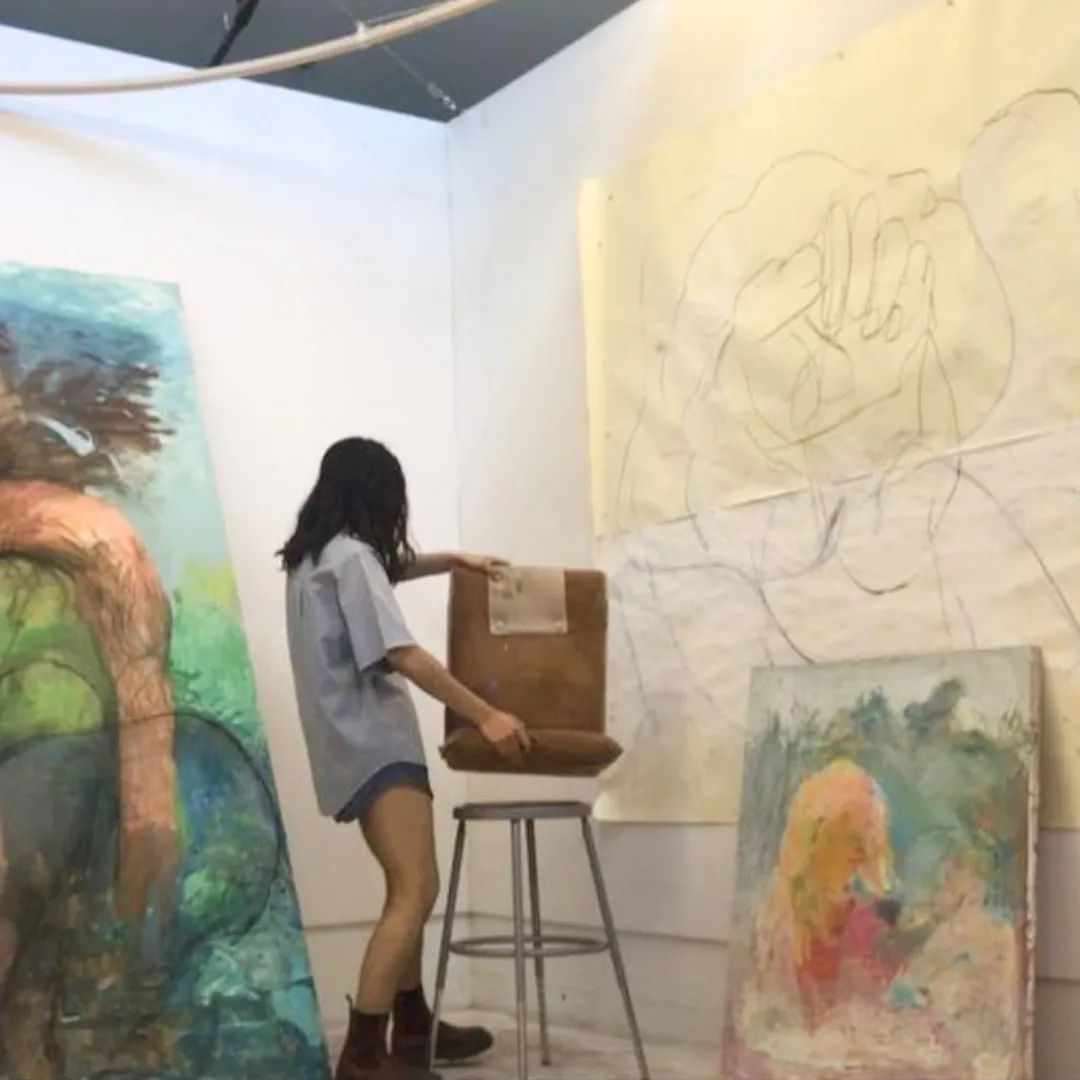 A student looks at artworks.
