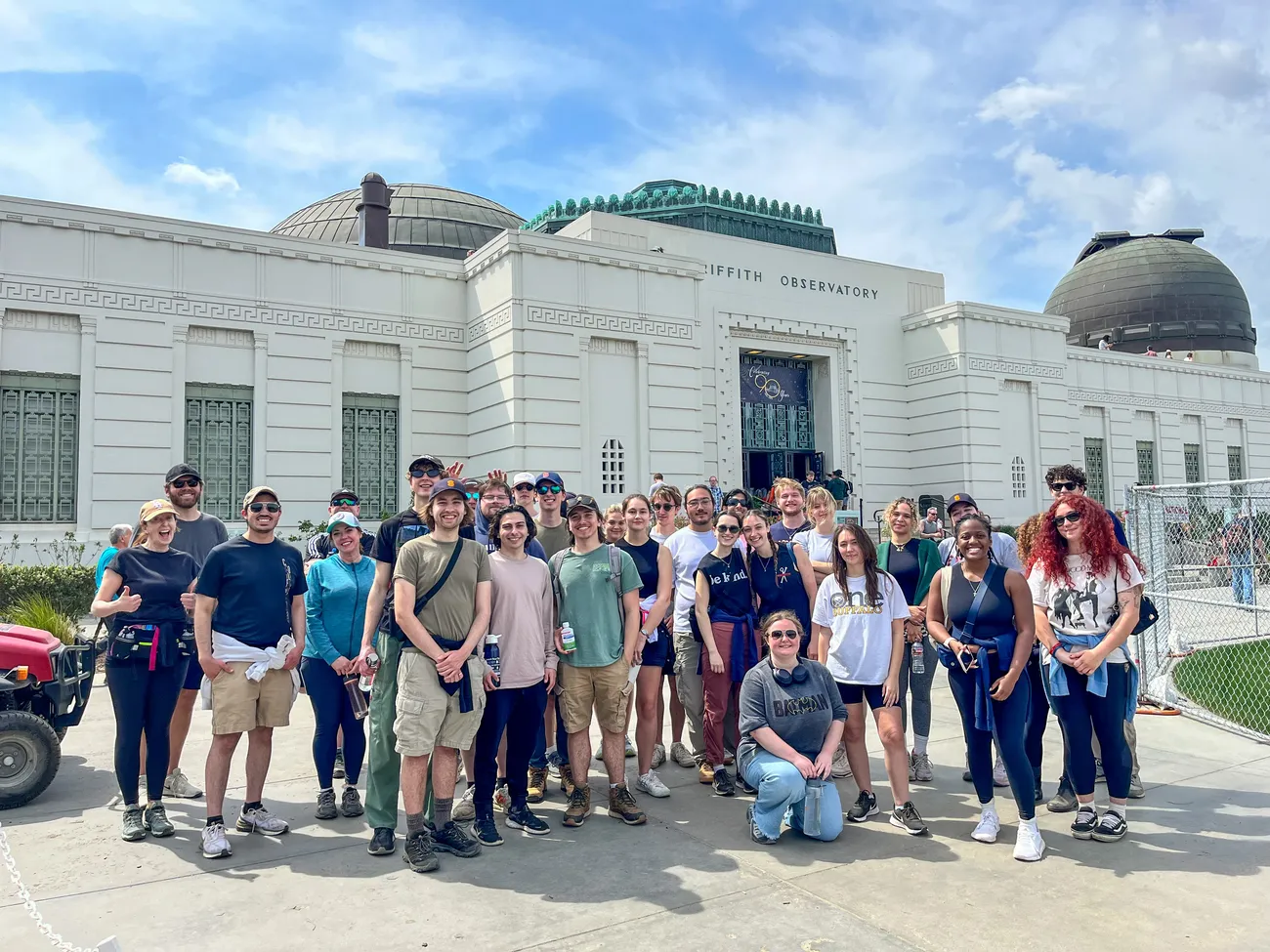 A group of students pose in front of an observatory.
