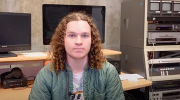 A film student in front of computers.