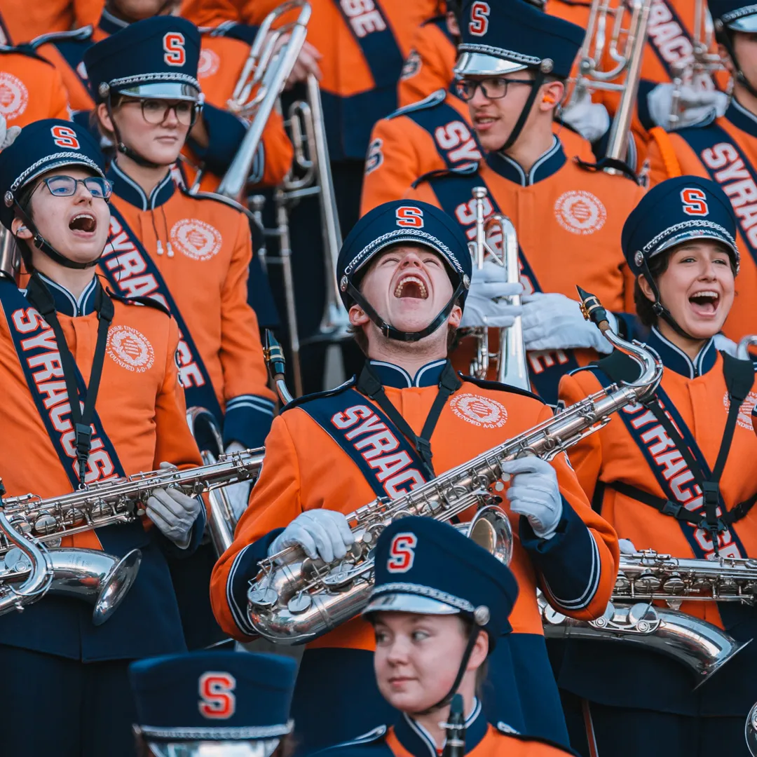 People in the Marching Band sing out.