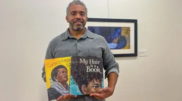London Ladd holds two books.
