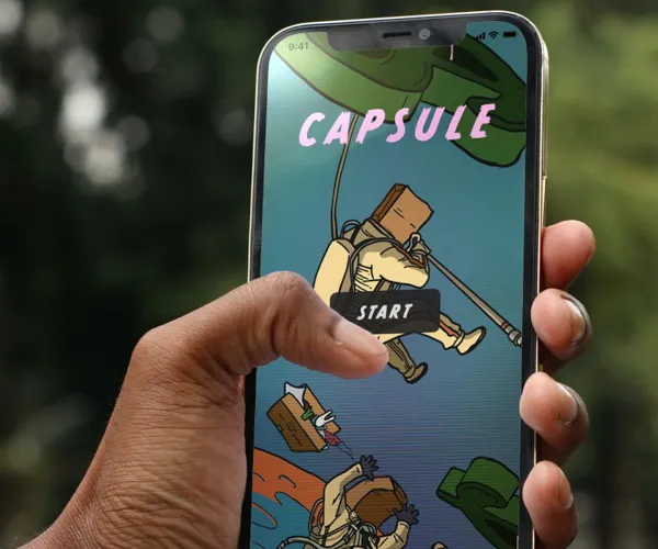 A person holds a phone with the app Capsule open.