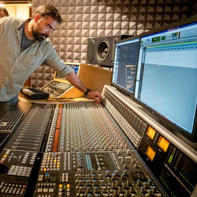 An individual works with sound recording equipment.