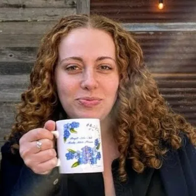 Caley Chase holds a mug.