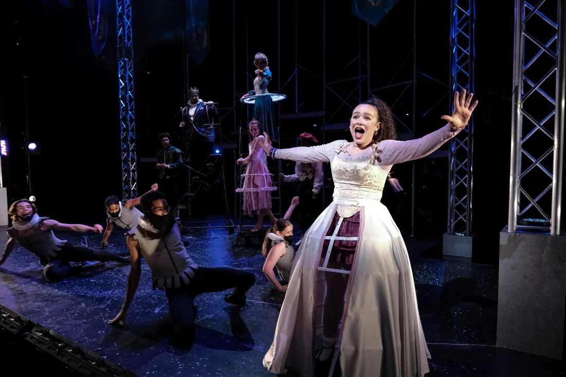 A student in costume on stage sings.