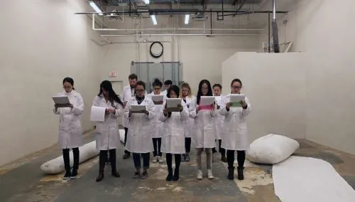 Individuals stand together in lab coats.