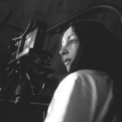 Kimberly Edelson stands behind a camera.